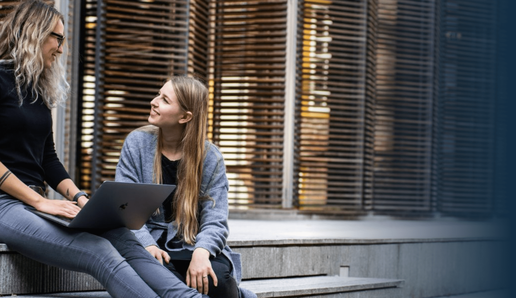 two women talking outside work